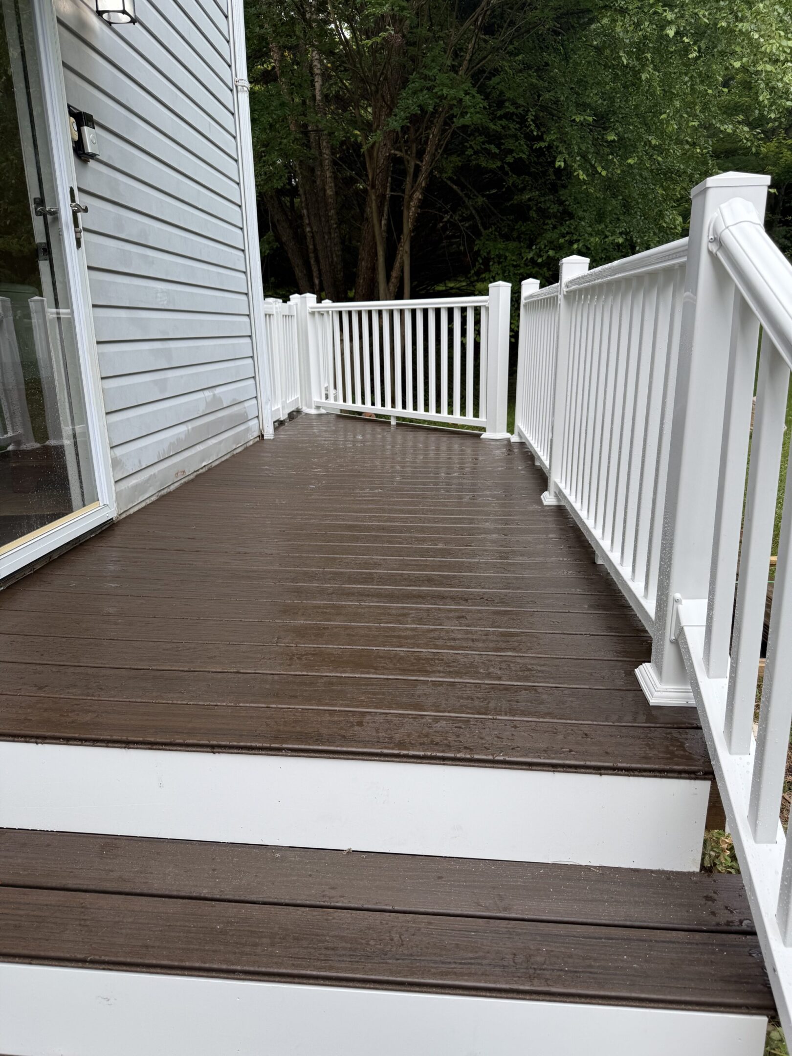 Rain-soaked deck beside a house
