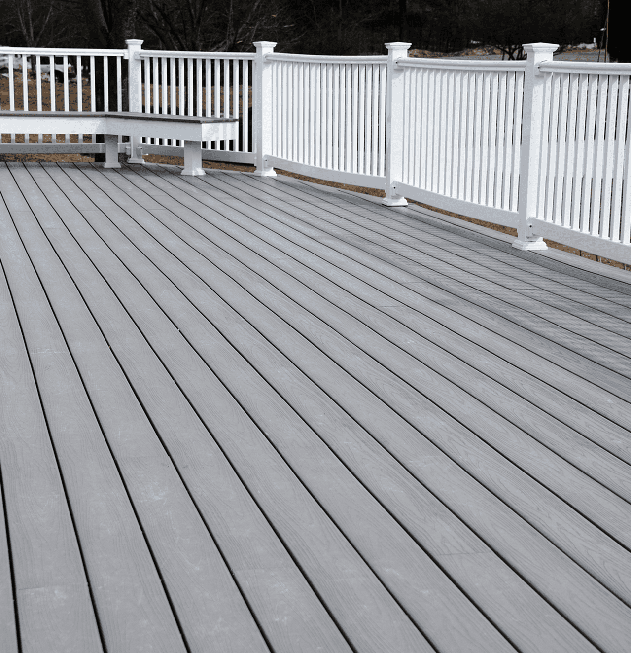 Spacious gray deck with white railing