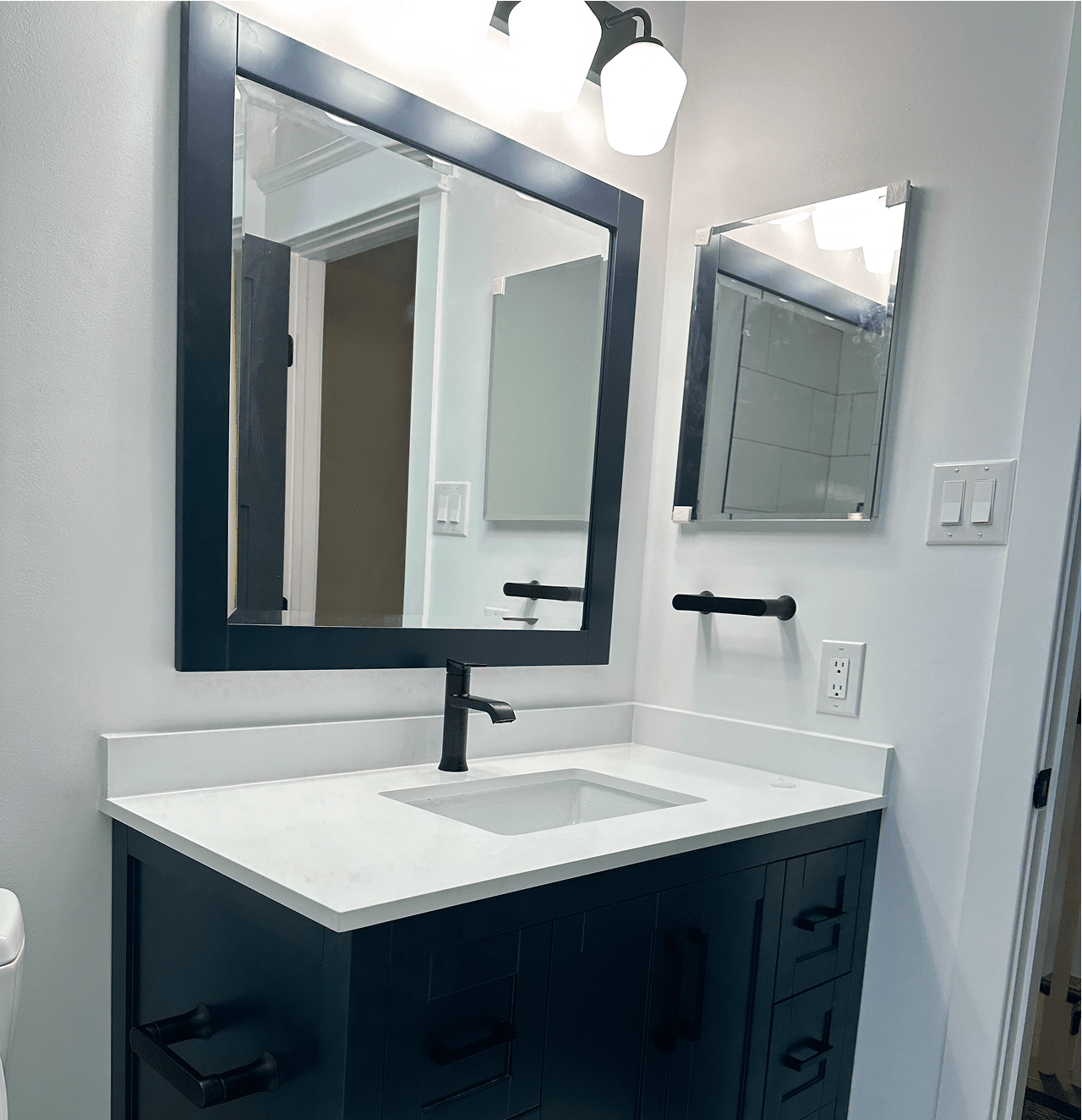 Bathroom vanity with sink and mirror.