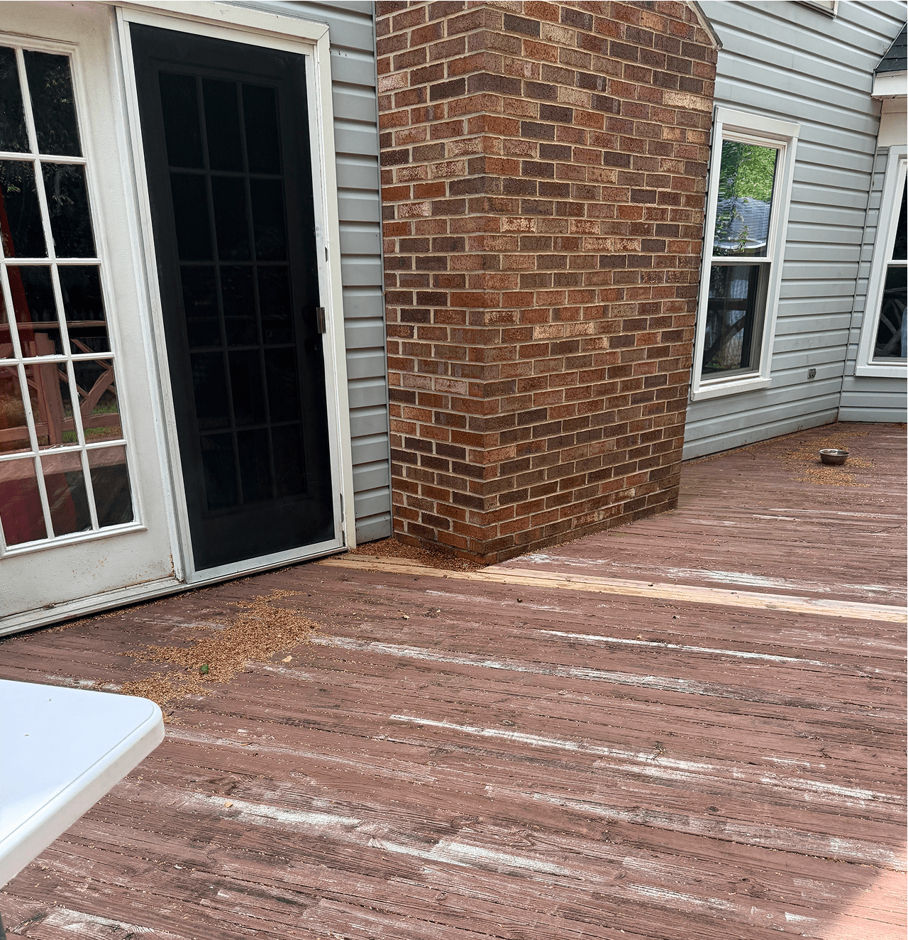 Brick chimney on wooden deck patio.
